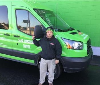 a man standing by a green van