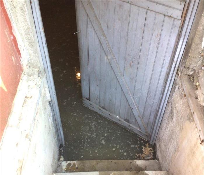 Standing water in basement entryway.