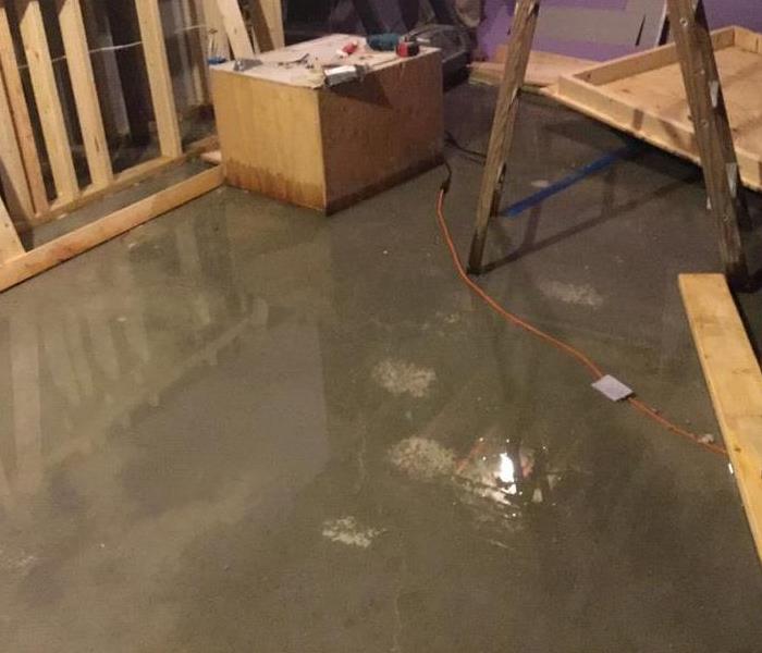 water on the concrete floor of a basement