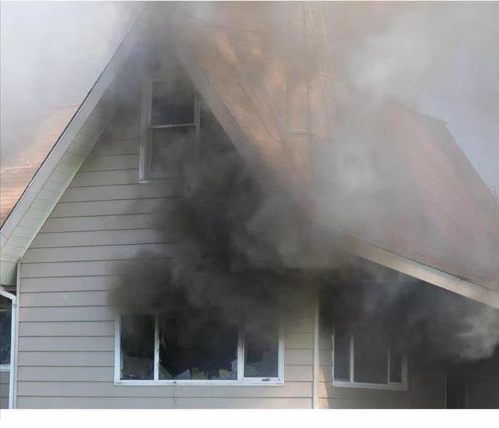 Black smoke coming out of a house